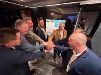 Texas Pete sales team celebrates success with all hands in the center at the 2024 NRA show.