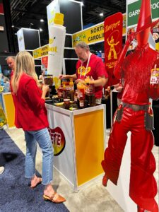 Two people discussing Swicy flavors in the Texas Pete booth at NRA show